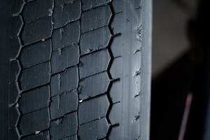 Detailed close-up of a worn tire tread showcasing grooves and patterns.