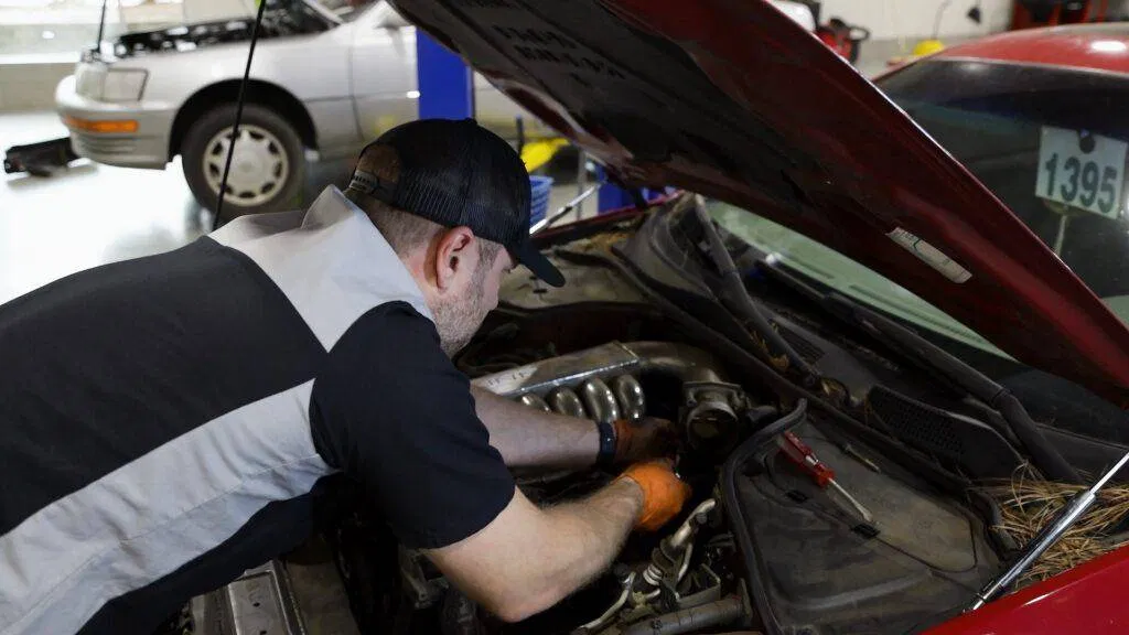 A mechanic at Japanese Auto Repair servicing a vehicle in the shop