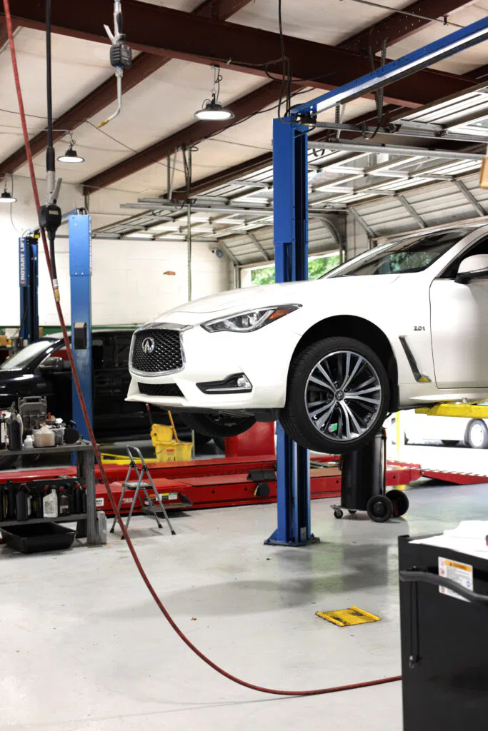 white car getting serviced for wheel noise