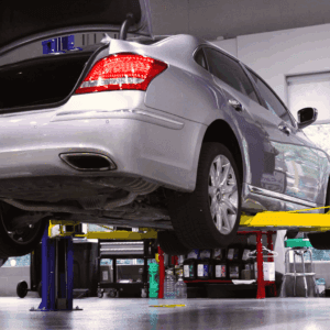 gray car lifted off of the ground with trunk open