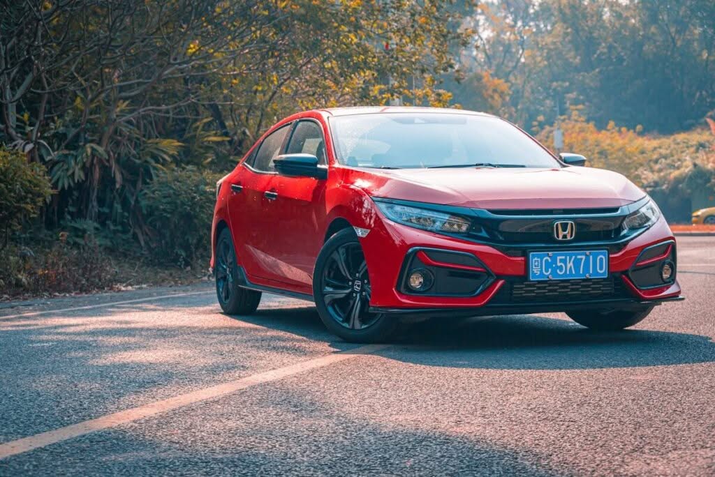 red honda on road during daytime